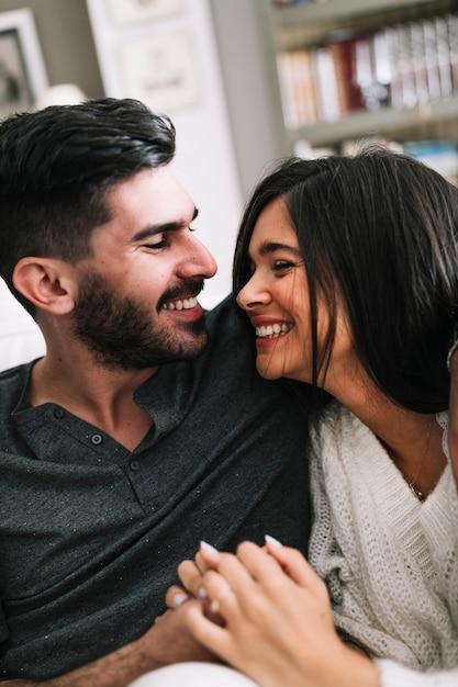 couple holding hands and smiling at each other, no phones