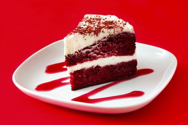 close-up of a sliced red velvet prism cake showing layers