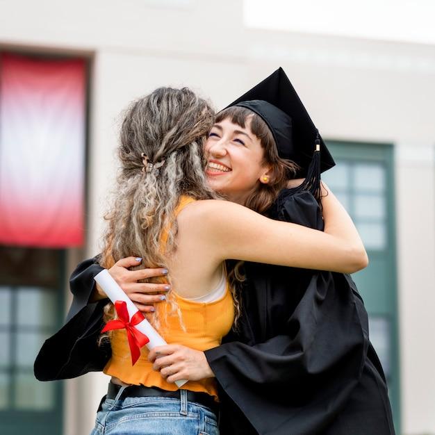 friends hugging at graduation