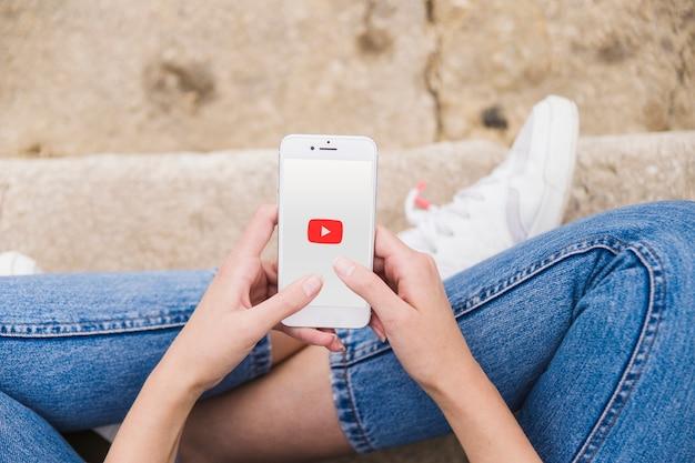 woman using YouTube premium app