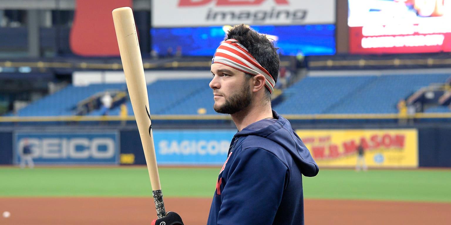 Softball player with long hair wearing a headband
