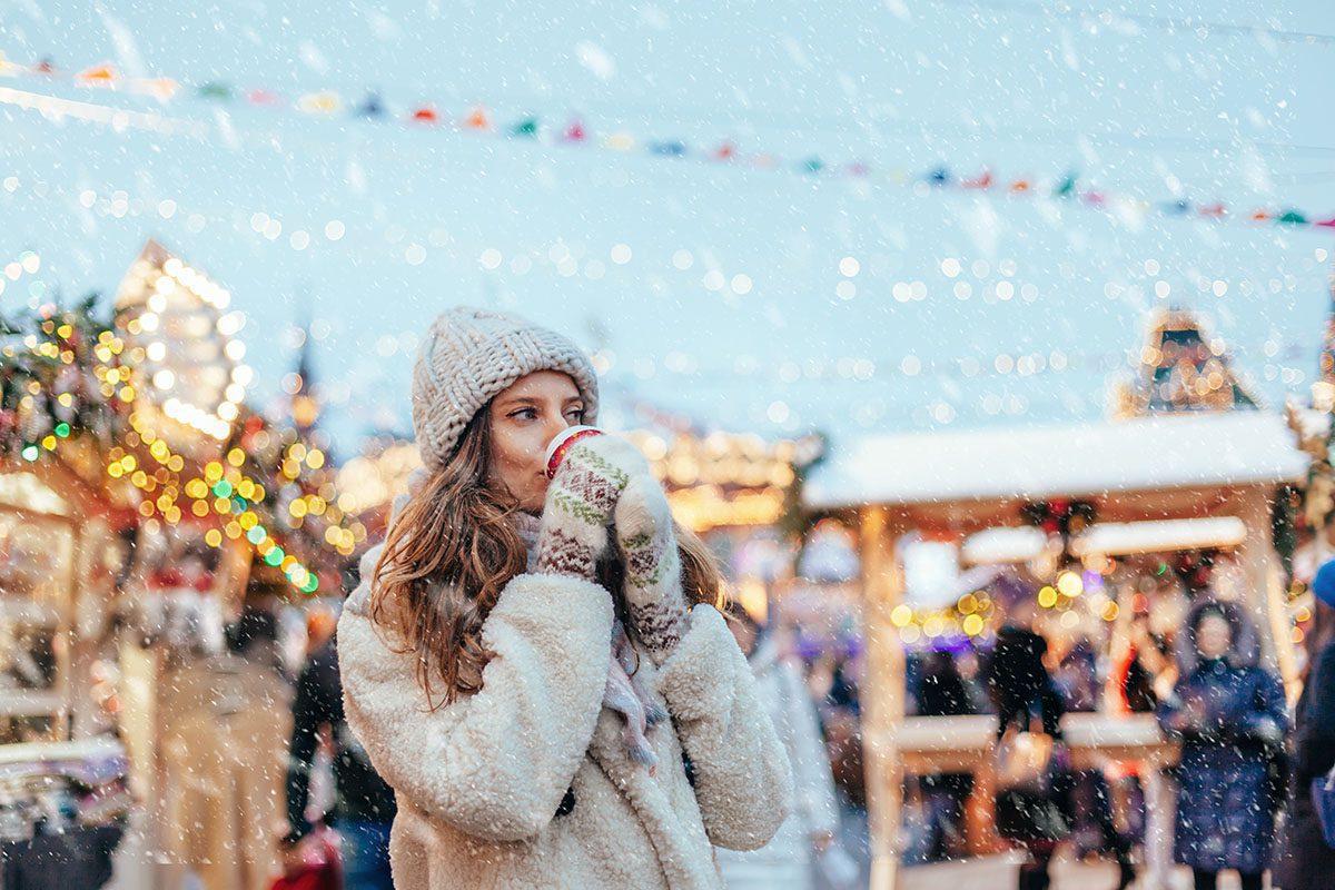woman enjoying winter market europe