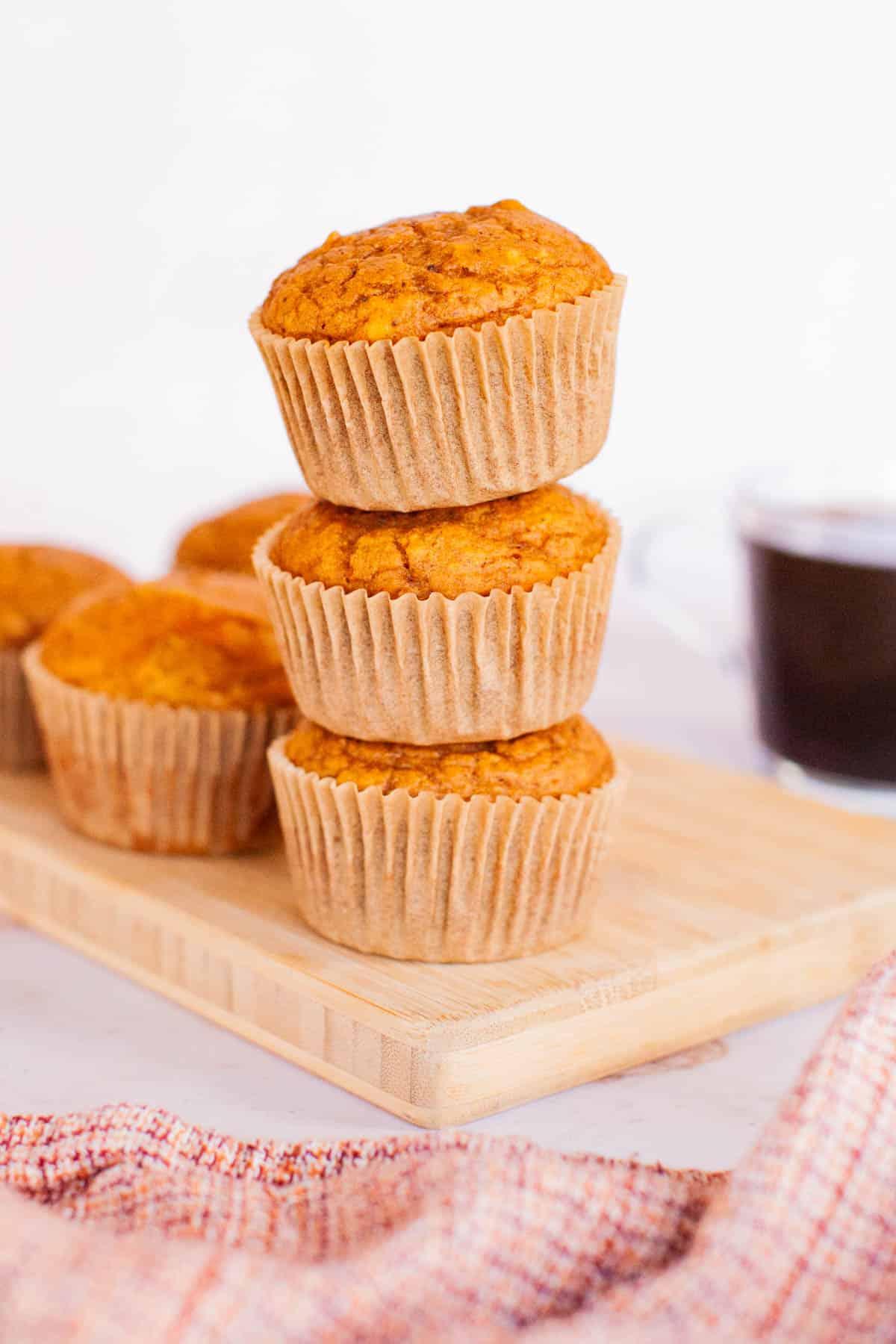 freshly baked pumpkin muffins on a wooden board