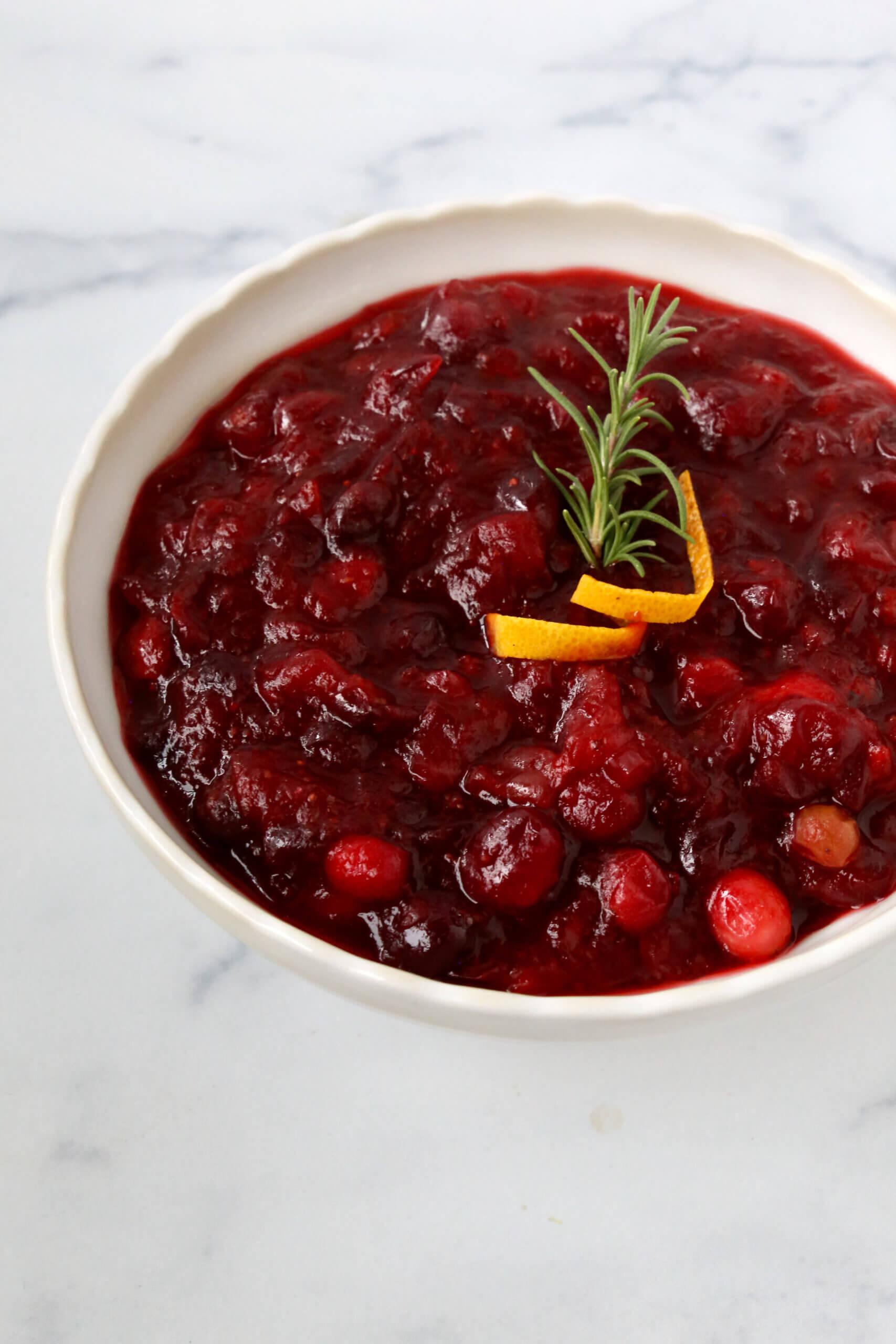 Homemade cranberry sauce in a rustic bowl on a holiday table, soft lighting