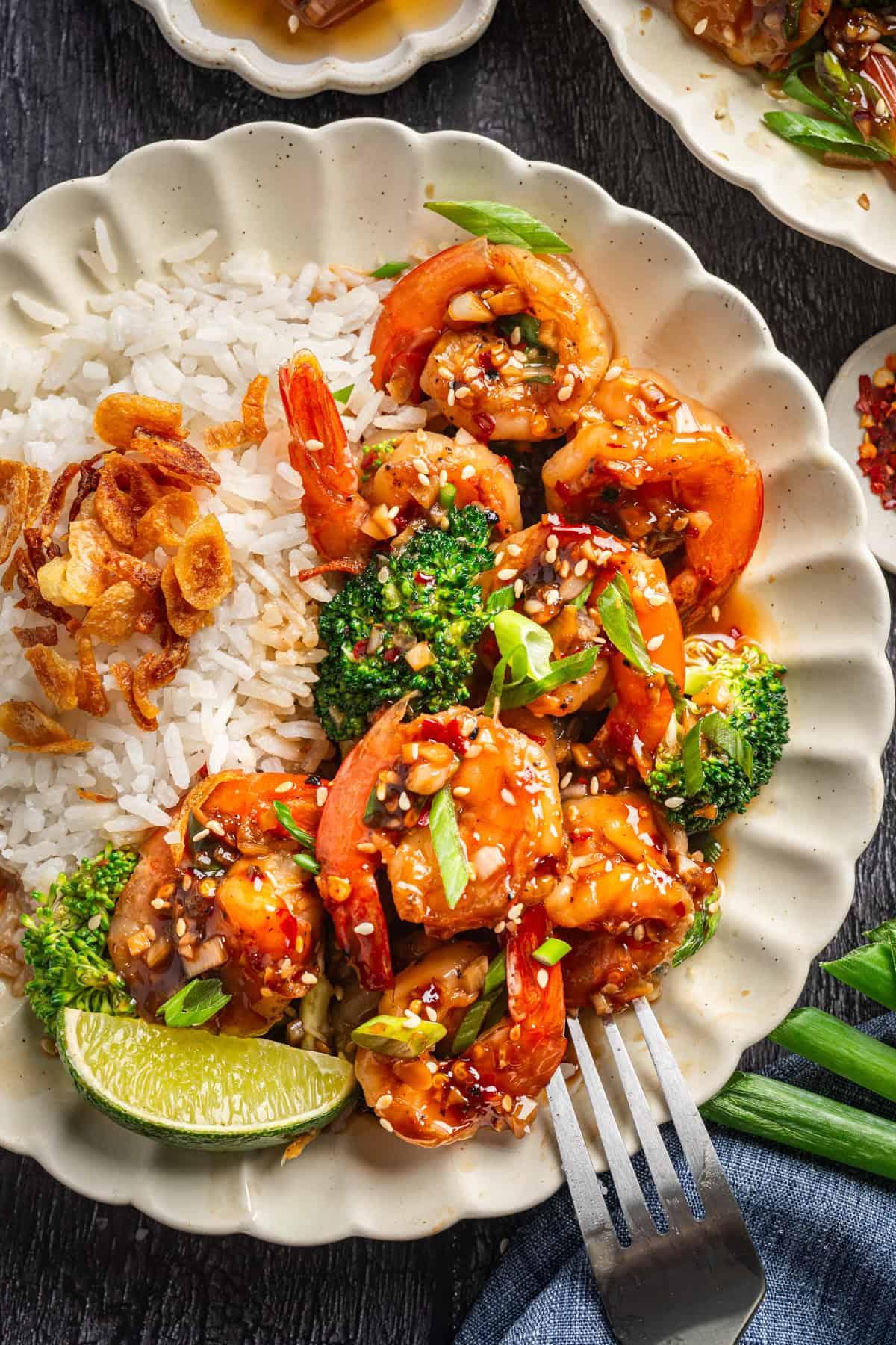 Plated honey garlic shrimp served with fluffy white rice and steamed broccoli
