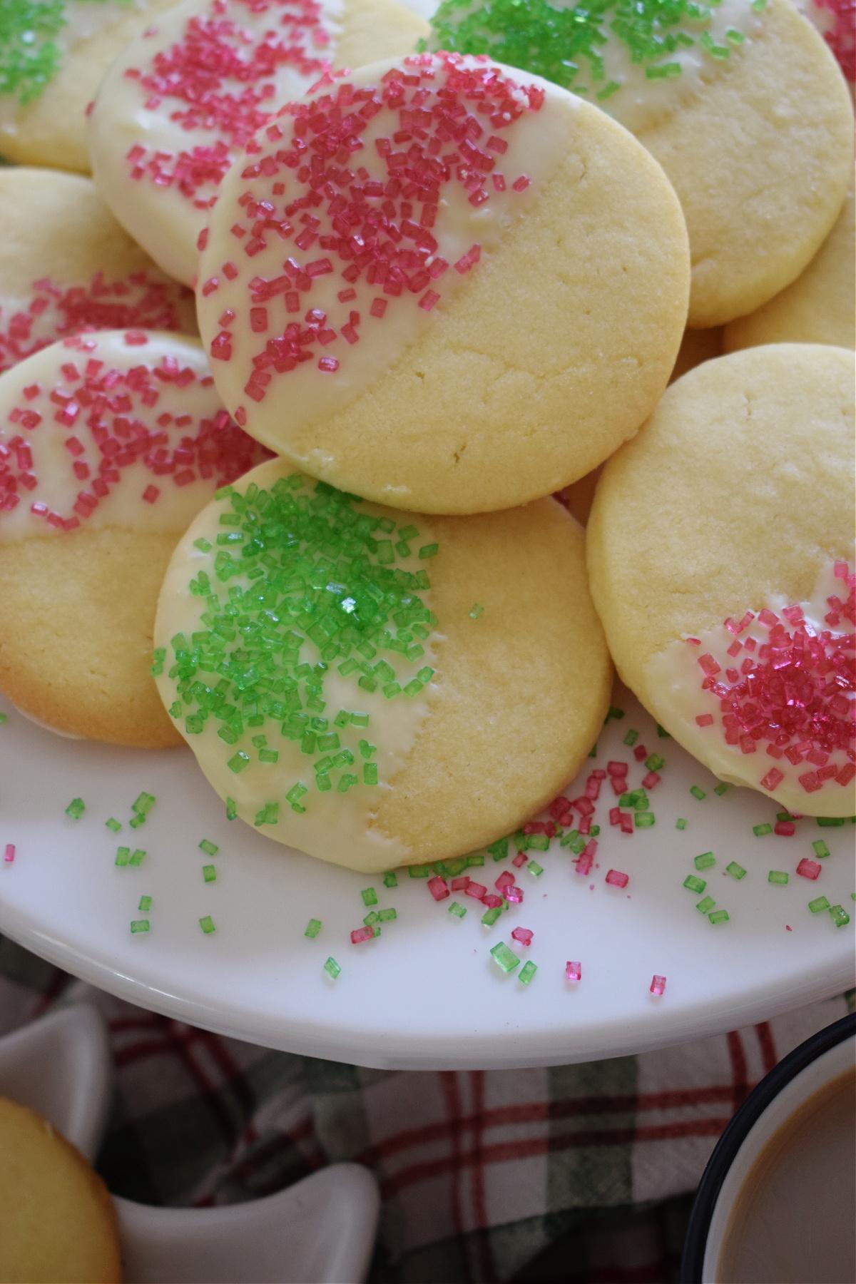 close-up of finished French tip shortbread cookies with white chocolate and festive sprinkles