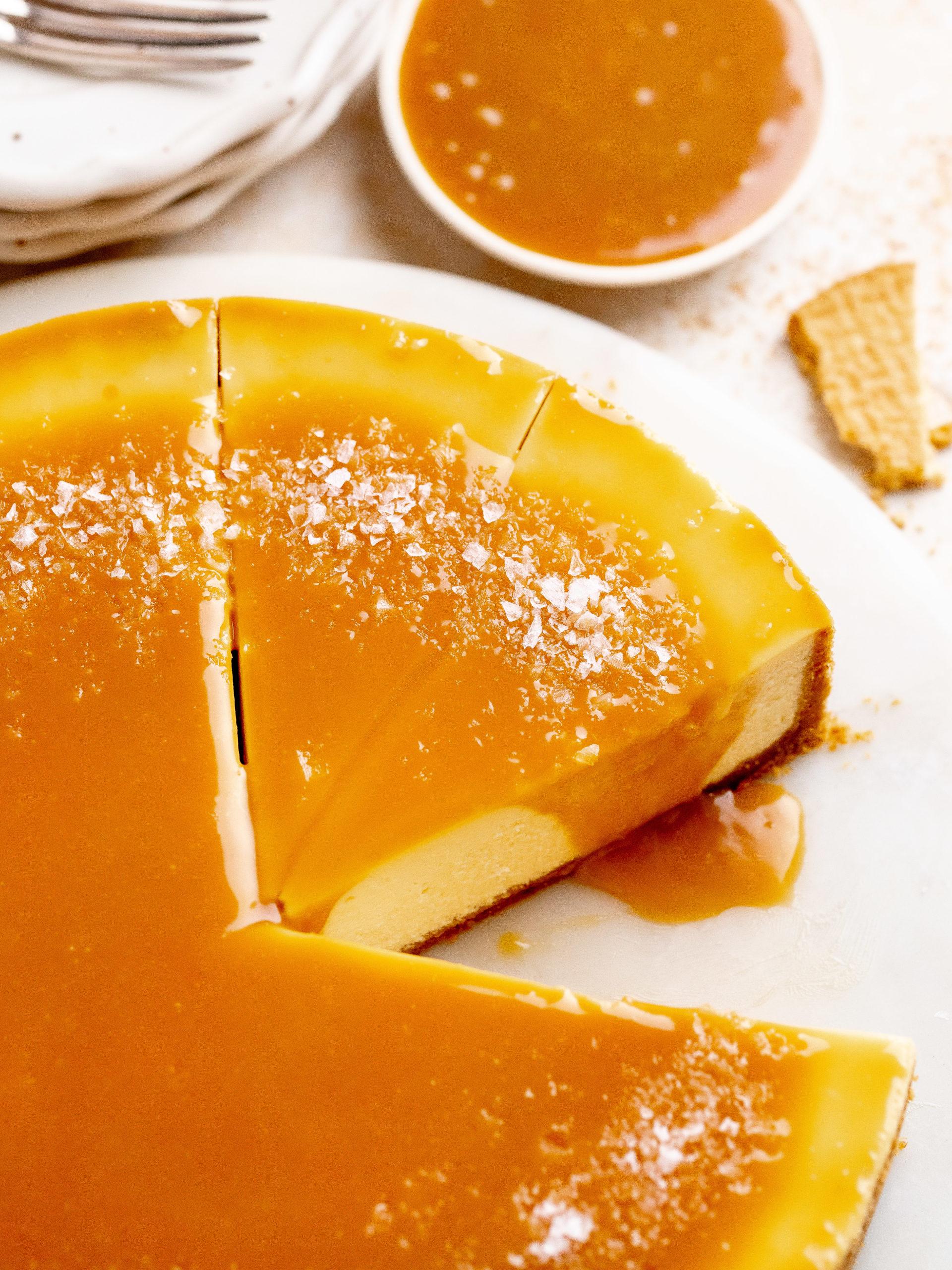 Close-up shot of a smooth, creamy caramel cheesecake with visible layers