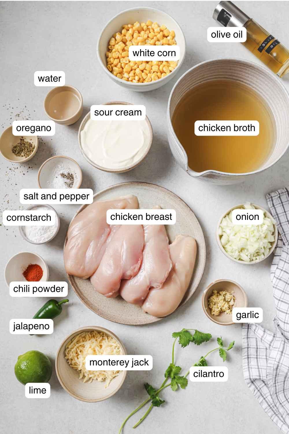 ingredients for white chicken chili arranged on a wooden countertop