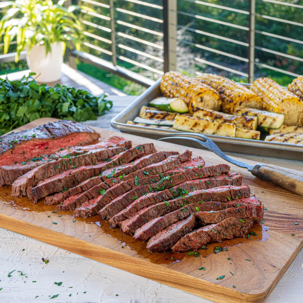 grilled sesame garlic flank steak on a cutting board