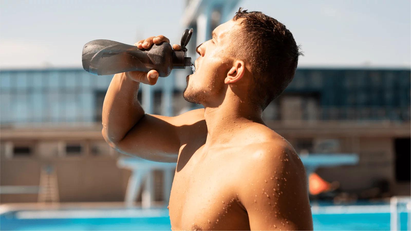 people drinking water and staying hydrated by a pool
