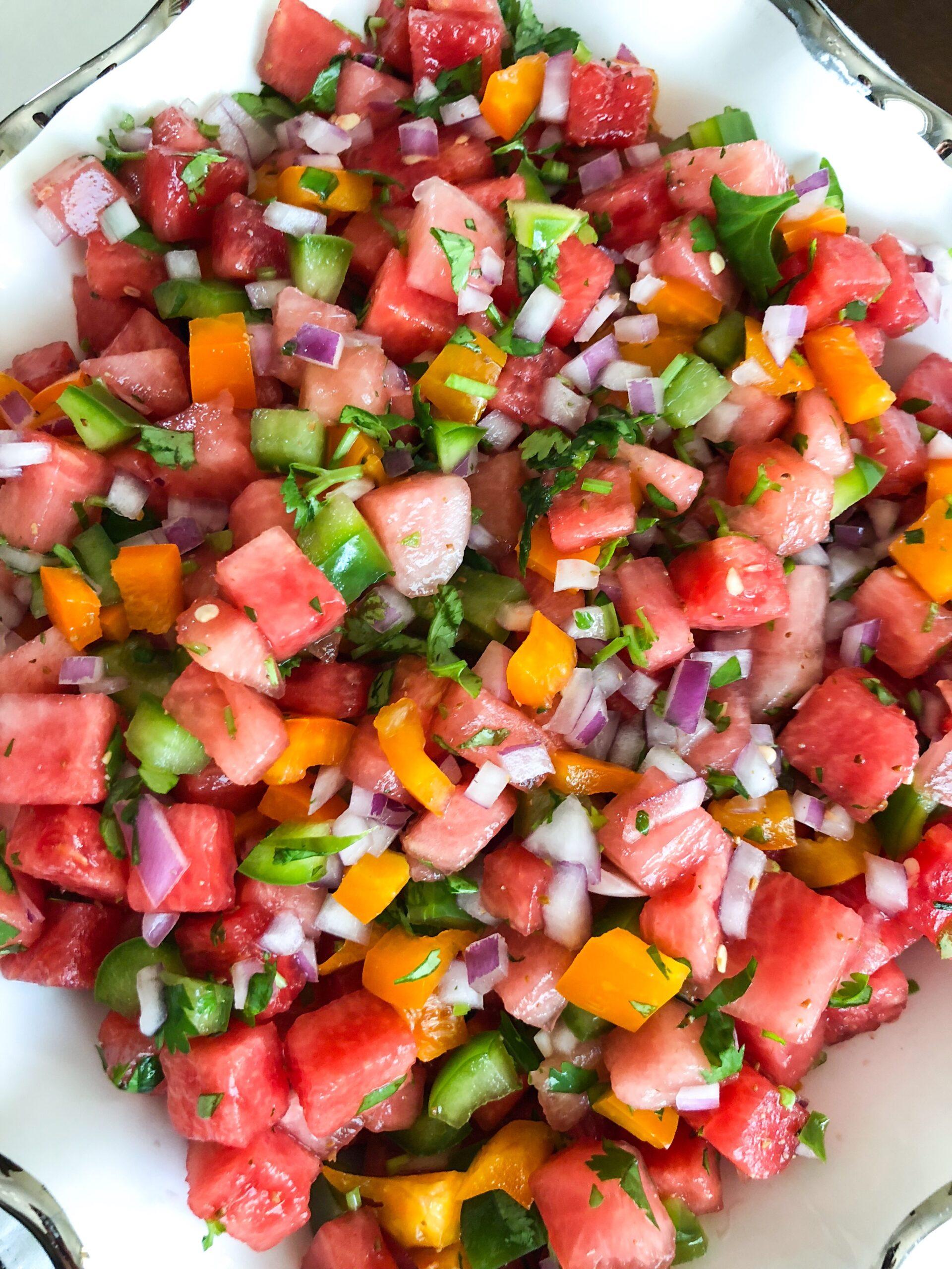 a person preparing watermelon jalapeno salsa