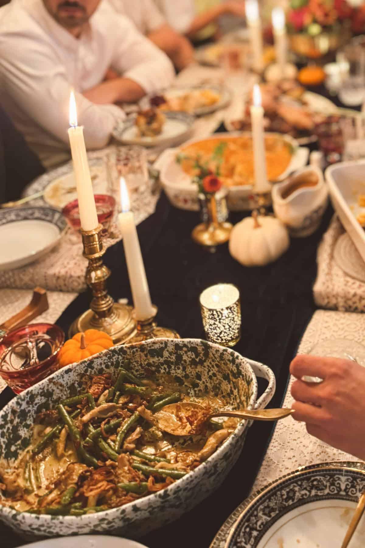 Vintage-style photo of a family laughing and enjoying a holiday meal with a green bean casserole on the table
