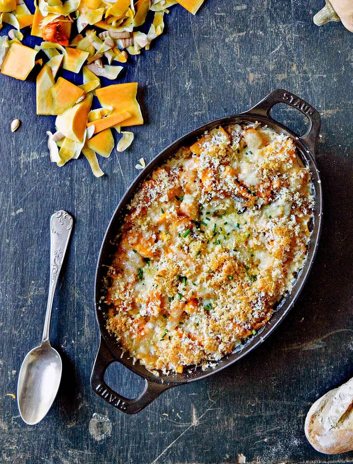Rustic kitchen scene, preparation of butternut squash for gratin