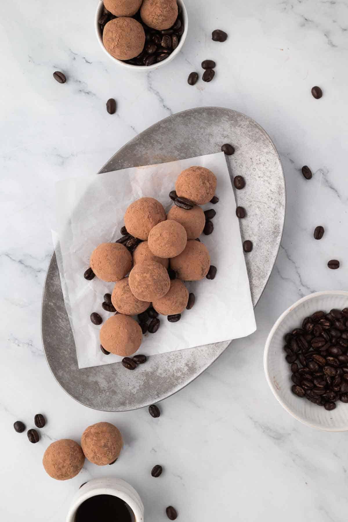 Homemade espresso truffles dusted with cocoa, arranged artfully on a plate