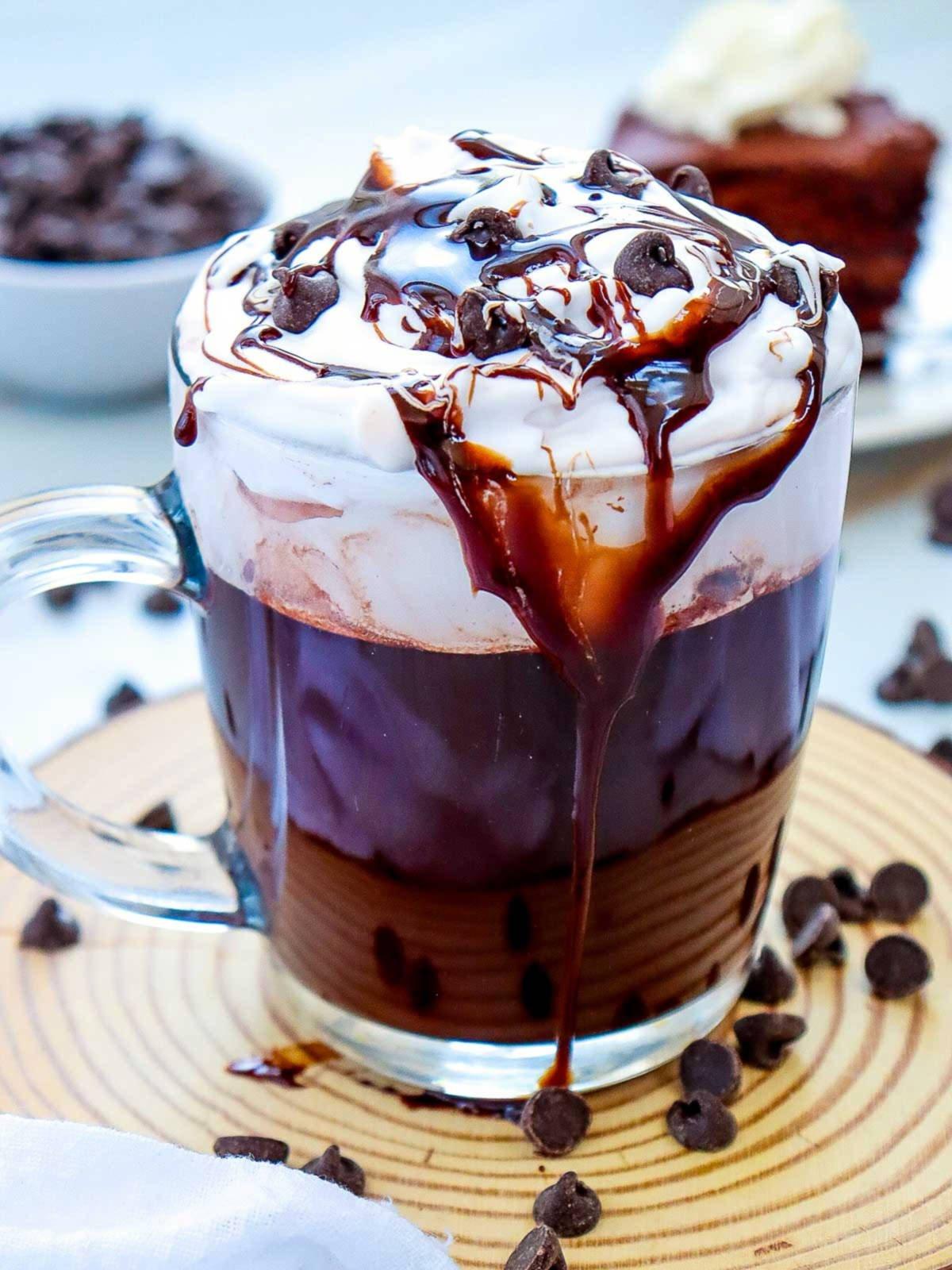 ingredients for mocha hot chocolate laid out on a kitchen counter, warm lighting