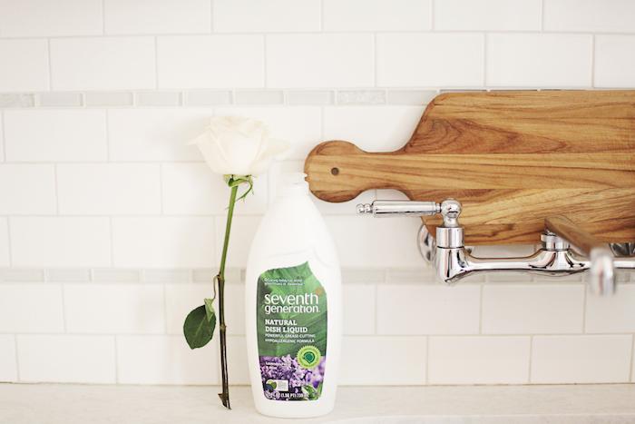 hands replacing chemical cleaners with natural alternatives under a sink