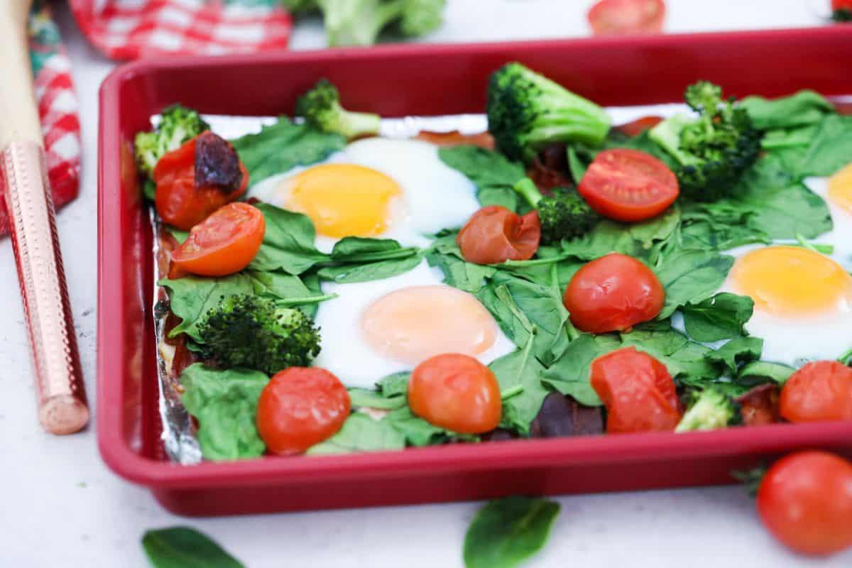 vibrant sheet pan breakfast with eggs, bacon, and colorful vegetables, bright morning light