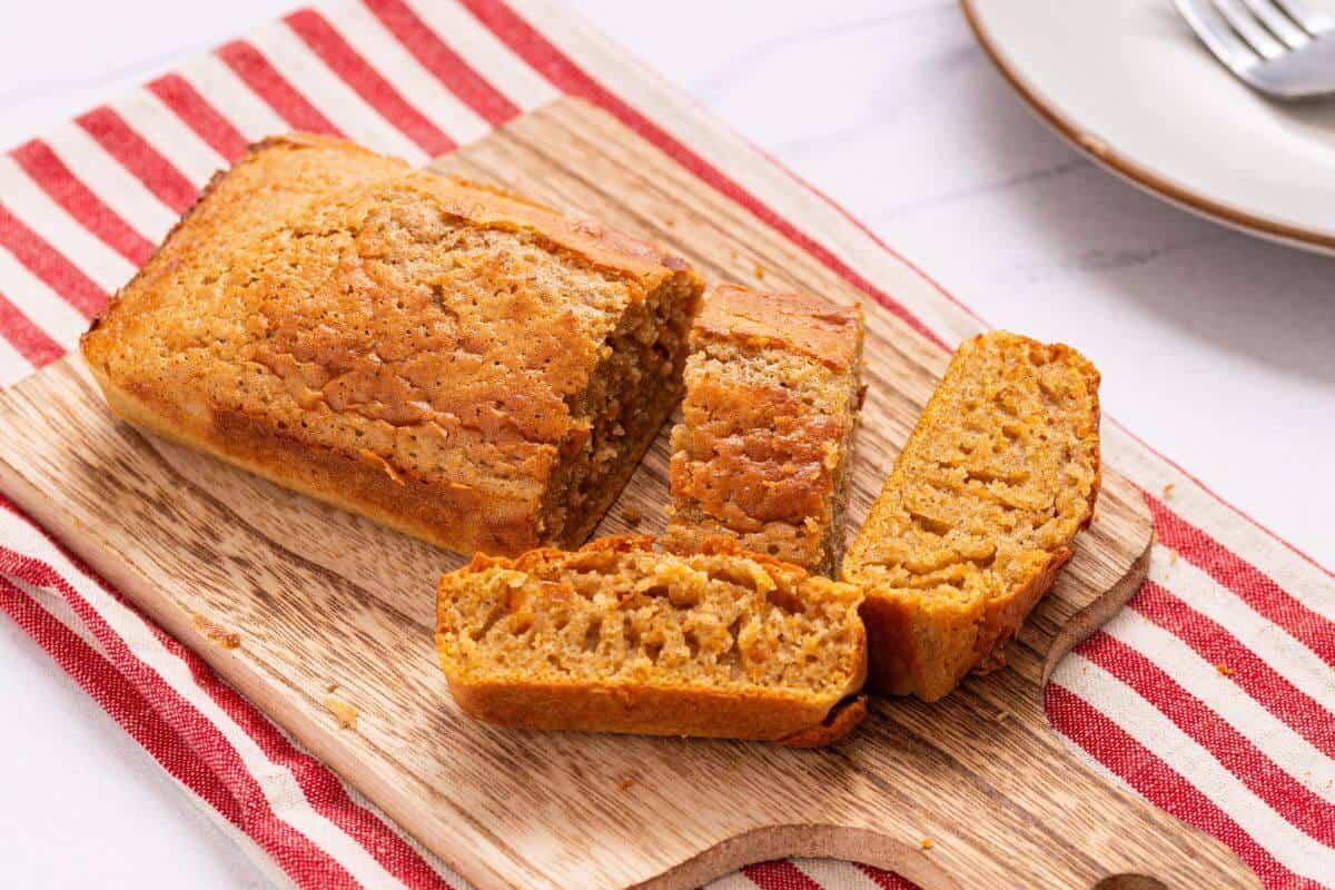 a slice of pumpkin bread on a plate with a fork