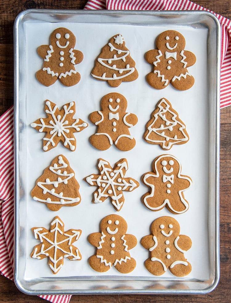 Decorated gingerbread cookies with royal icing, some shaped as stars and gingerbread men