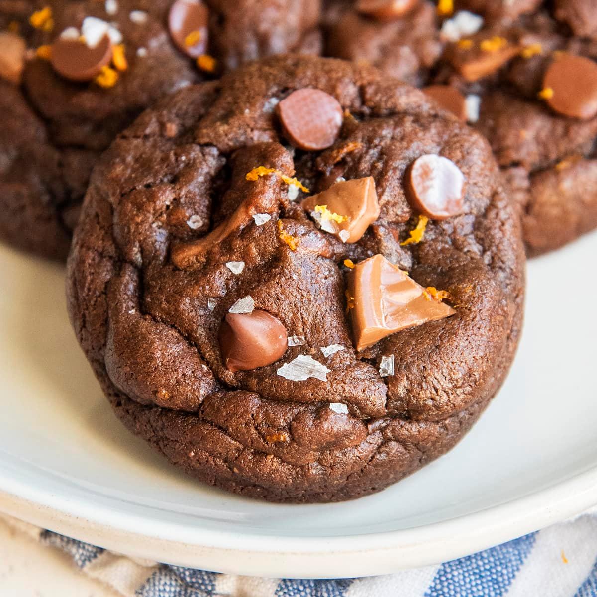 close-up of a chocolate orange cookie with a visibly glossy, crackled top