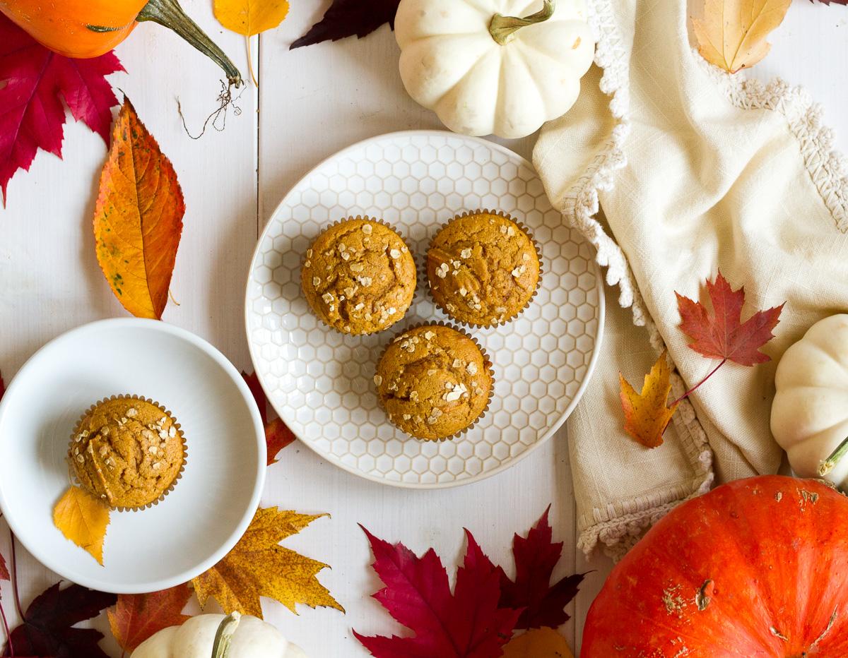 overhead shot of freshly baked pumpkin spice muffins with fall leaves