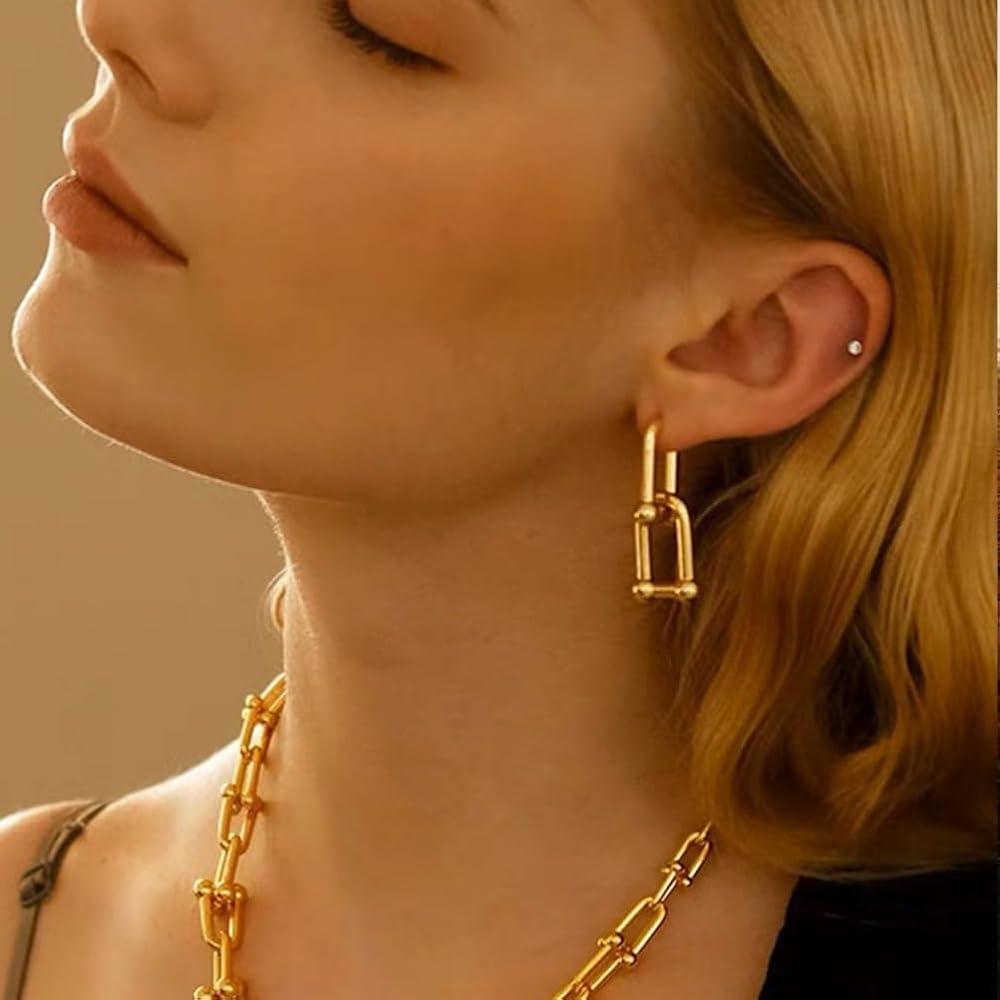woman smiling confidently while wearing chunky chain earrings