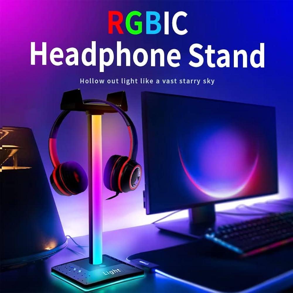 a desk with tech accessories like a laptop stand, colorful phone charger, and headphones