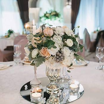 a mirrored tray centerpiece with candles and ornaments