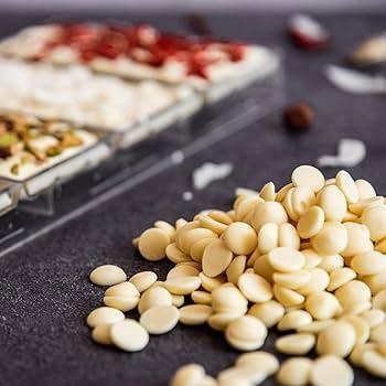 White chocolate drops melting, close up, gourmet