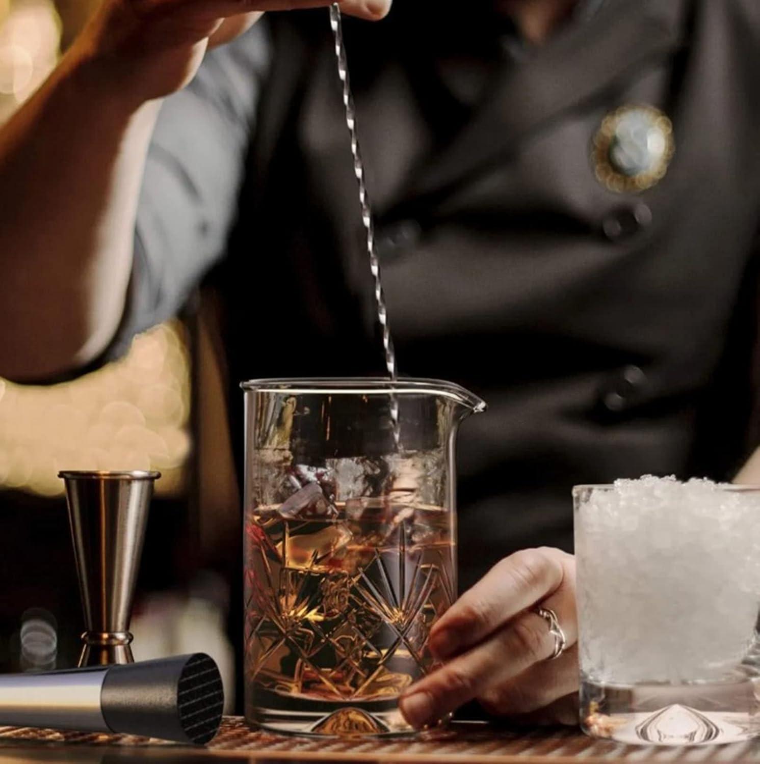 bartender mixing a virgin mojito with a muddler