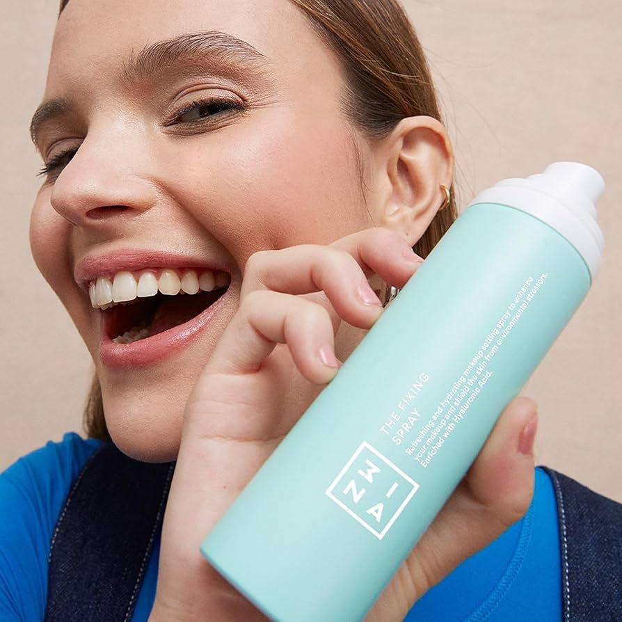 woman holding a setting spray bottle