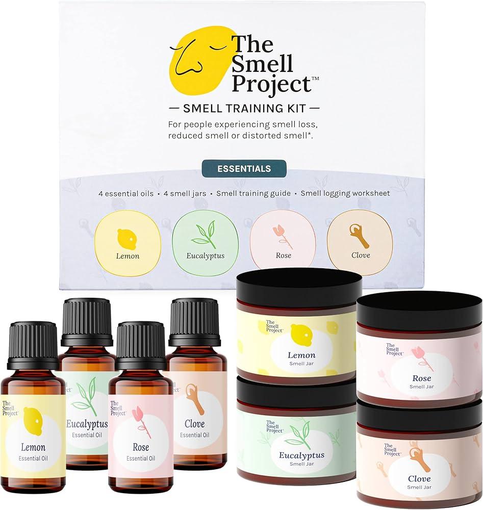 Person smelling different essential oils from bottles