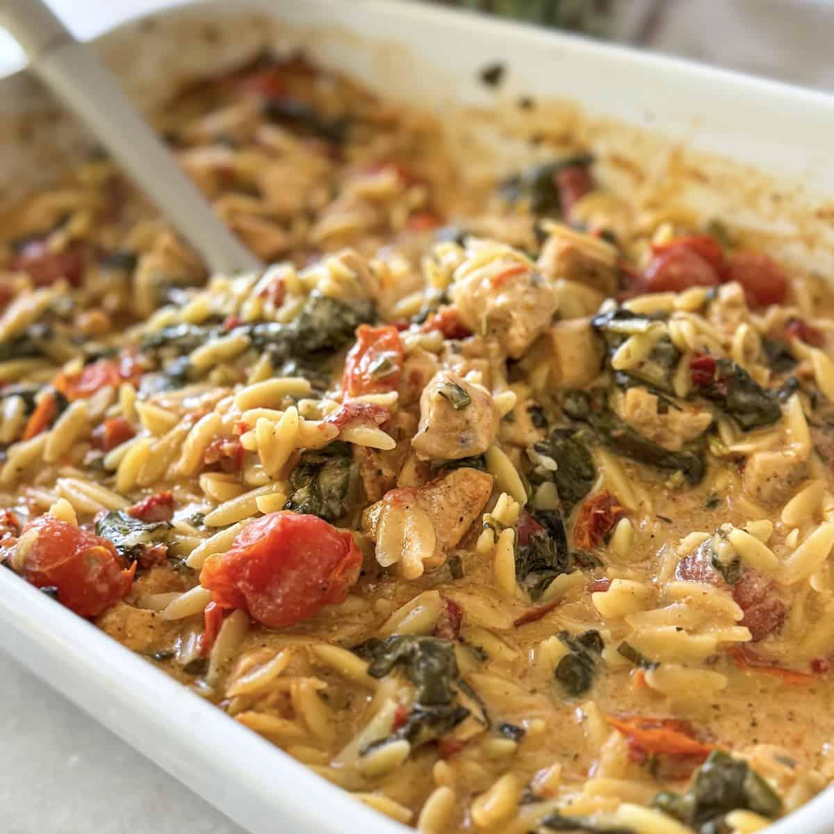 overhead shot of Mediterranean Zucchini and Orzo Bake with a serving spoon