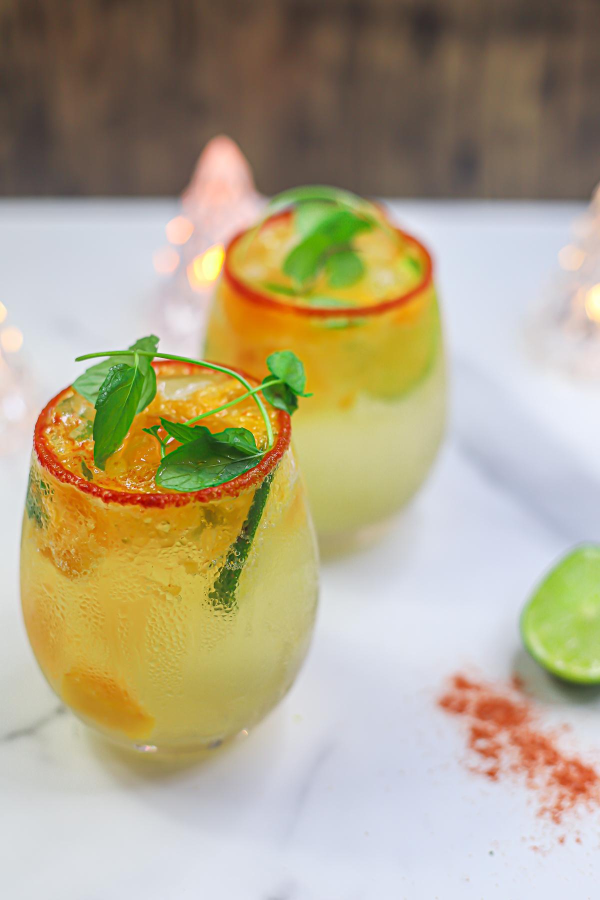 a plate of spicy mango churros with chili lime sugar, garnished with fresh mint leaves