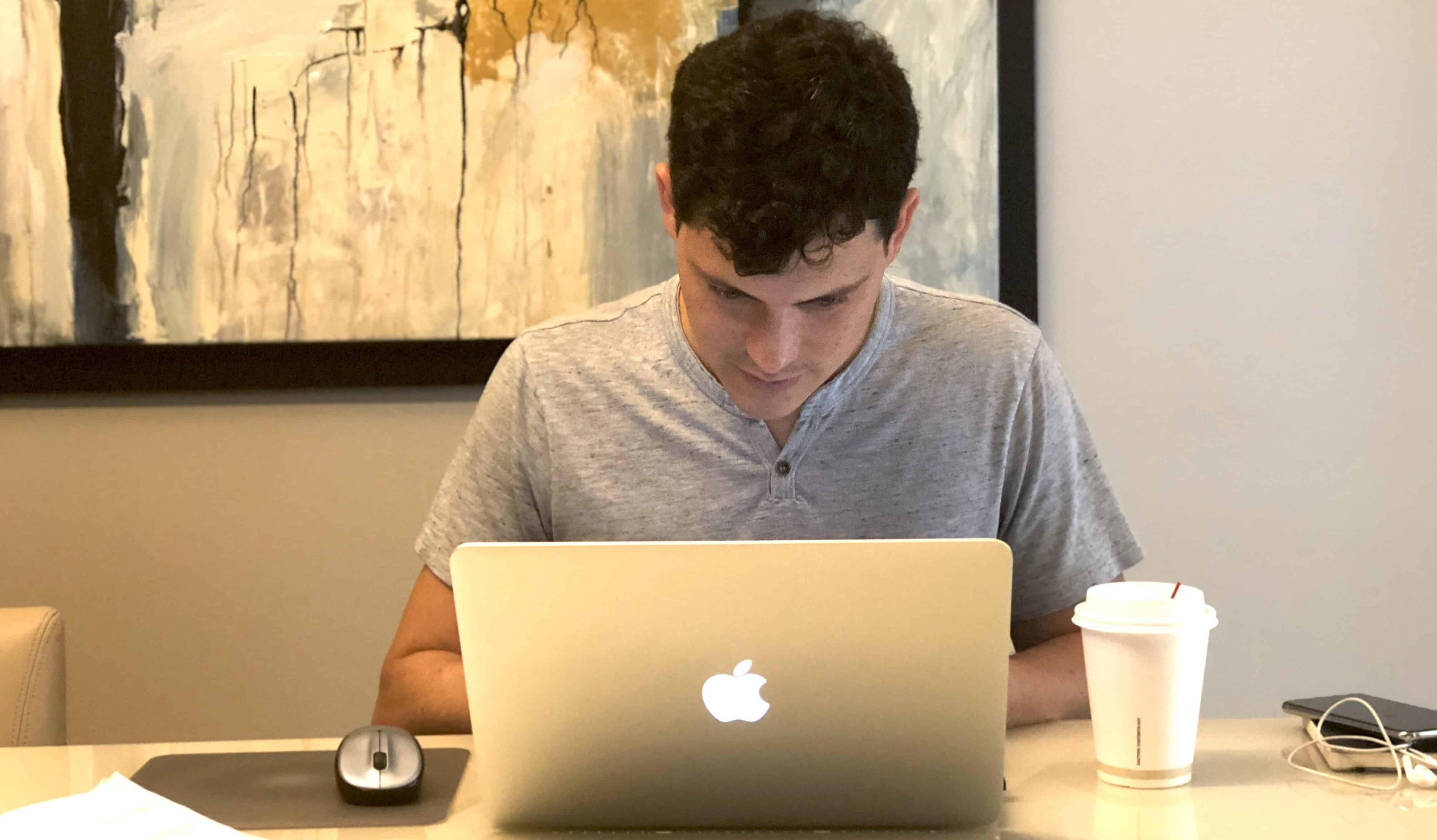 travel blogger creating content on laptop