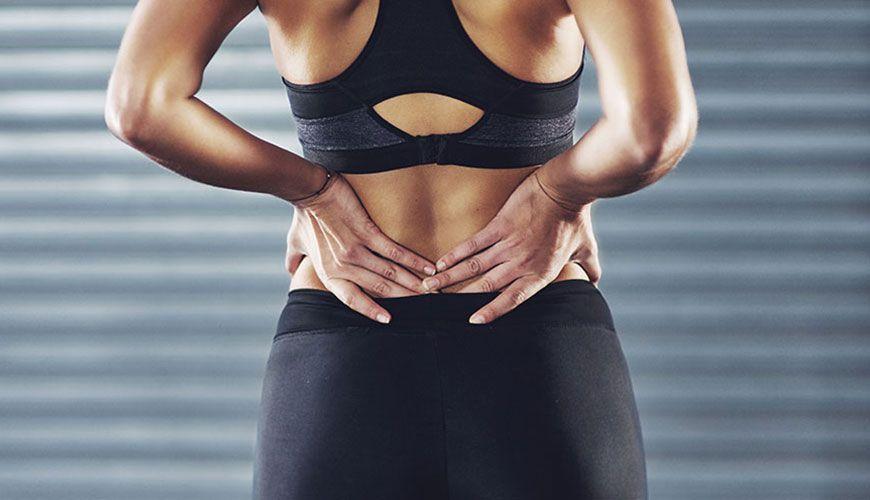 woman wincing in pain during a workout