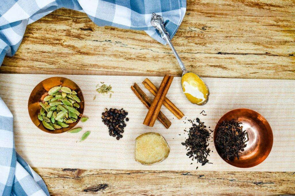 chai latte ingredients laid out on a wooden table