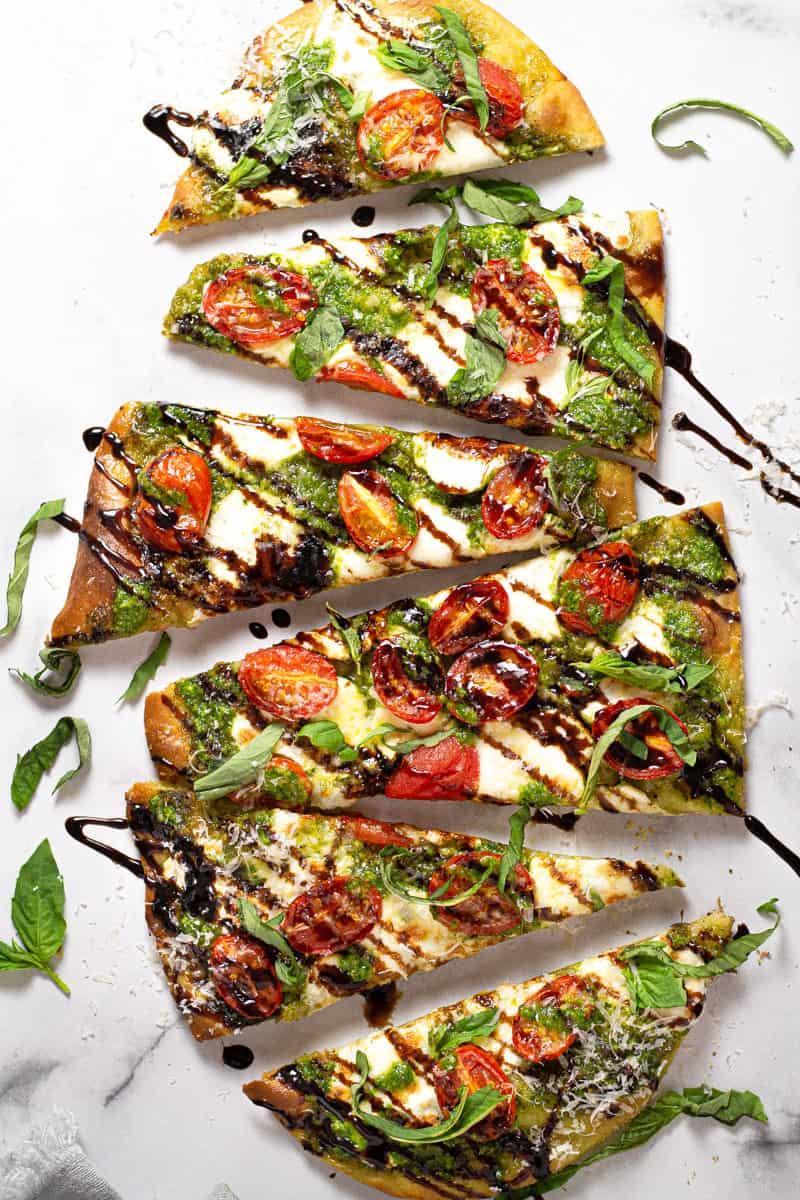 overhead shot of a prepared grilled tomato and basil flatbread