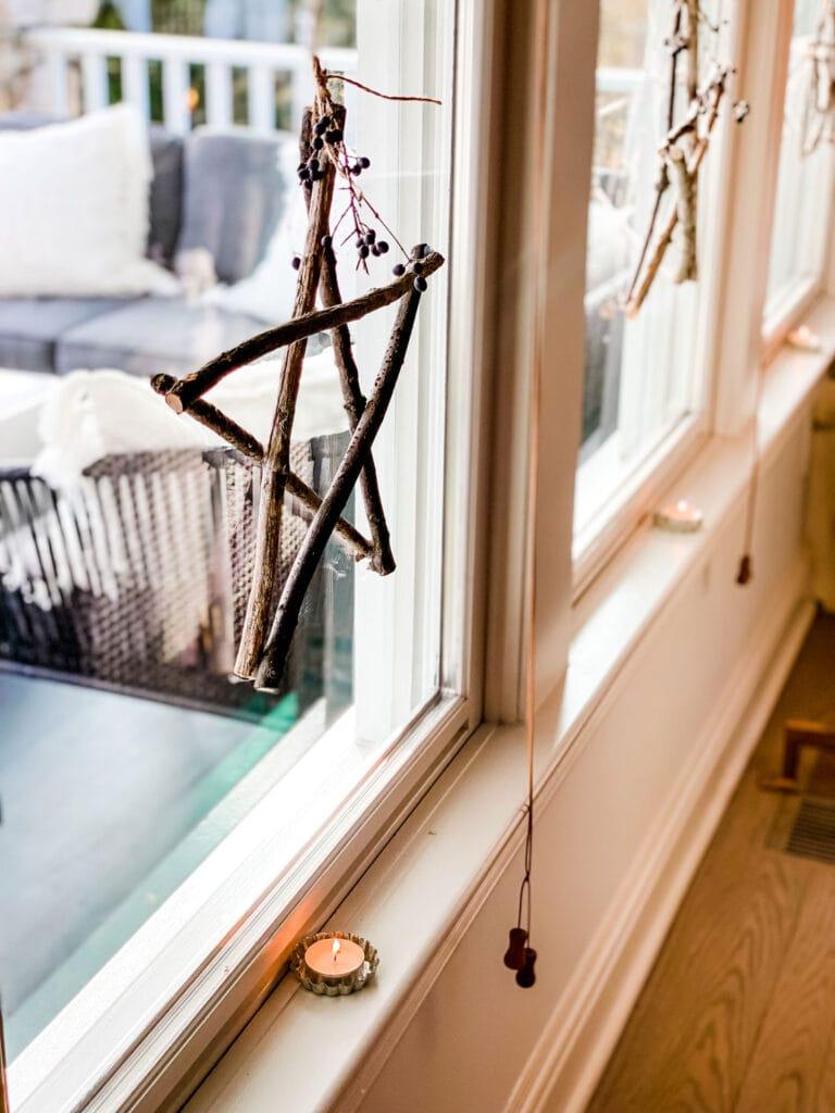 Handmade twig stars hanging in a window