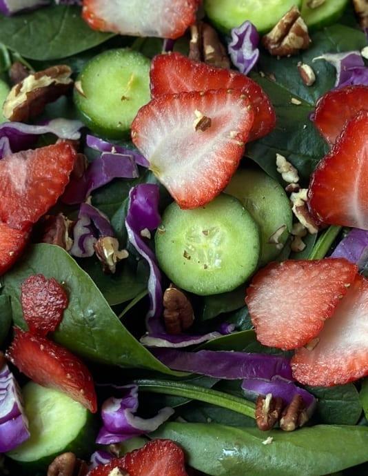 Close-up shot of fresh strawberries and spinach