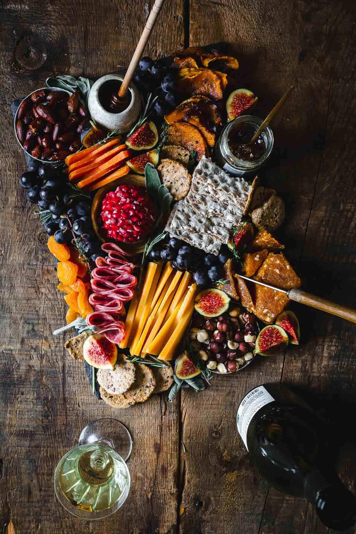 a beautifully arranged fall charcuterie board on a wooden table