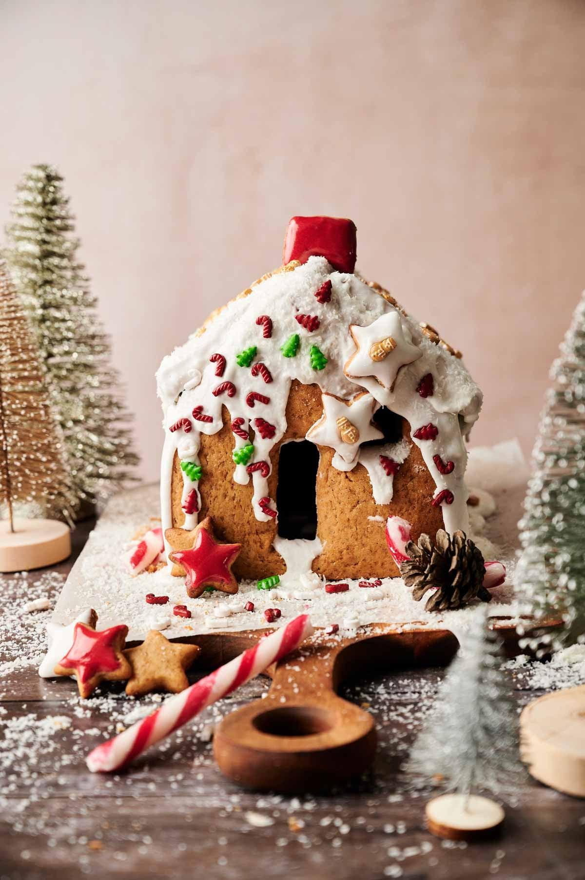 beautifully decorated gingerbread house with soft cookie walls, festive lighting, warm cozy atmosphere