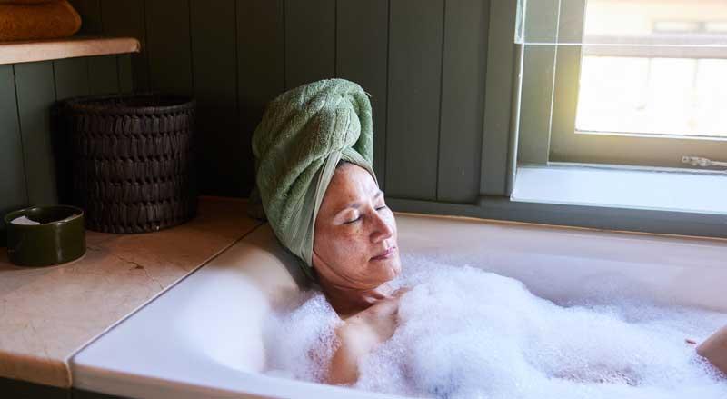 woman relaxing and practicing self-care