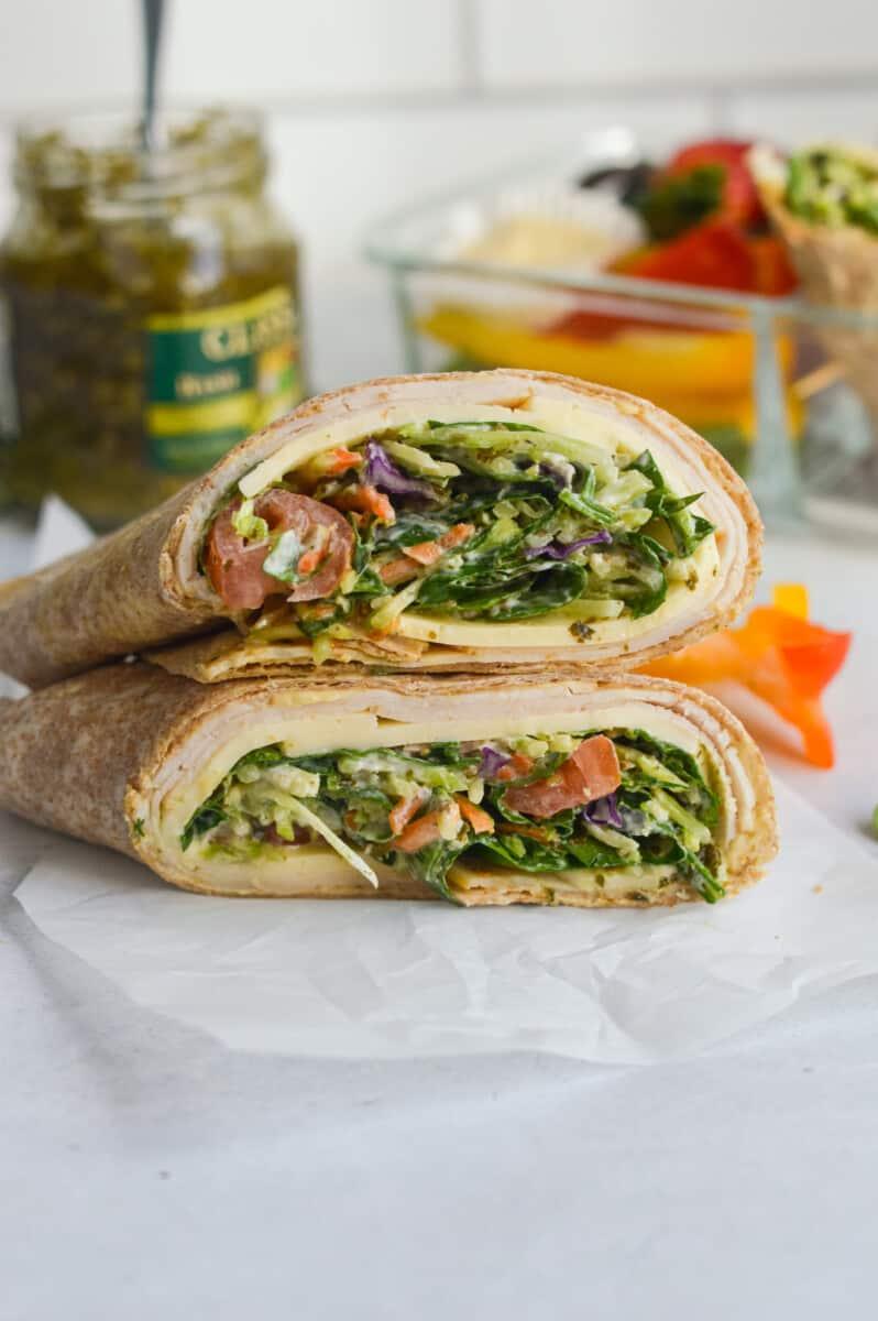 close up of a freshly made creamy chicken spinach wrap being sliced in half