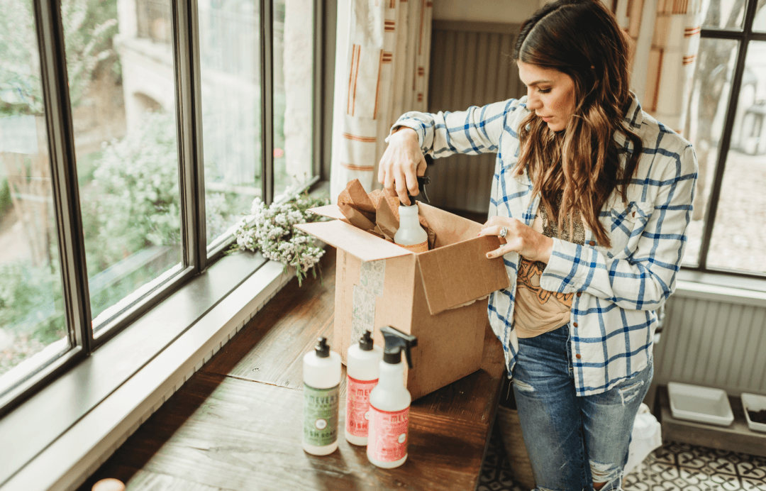 happy woman cleaning her home with natural products