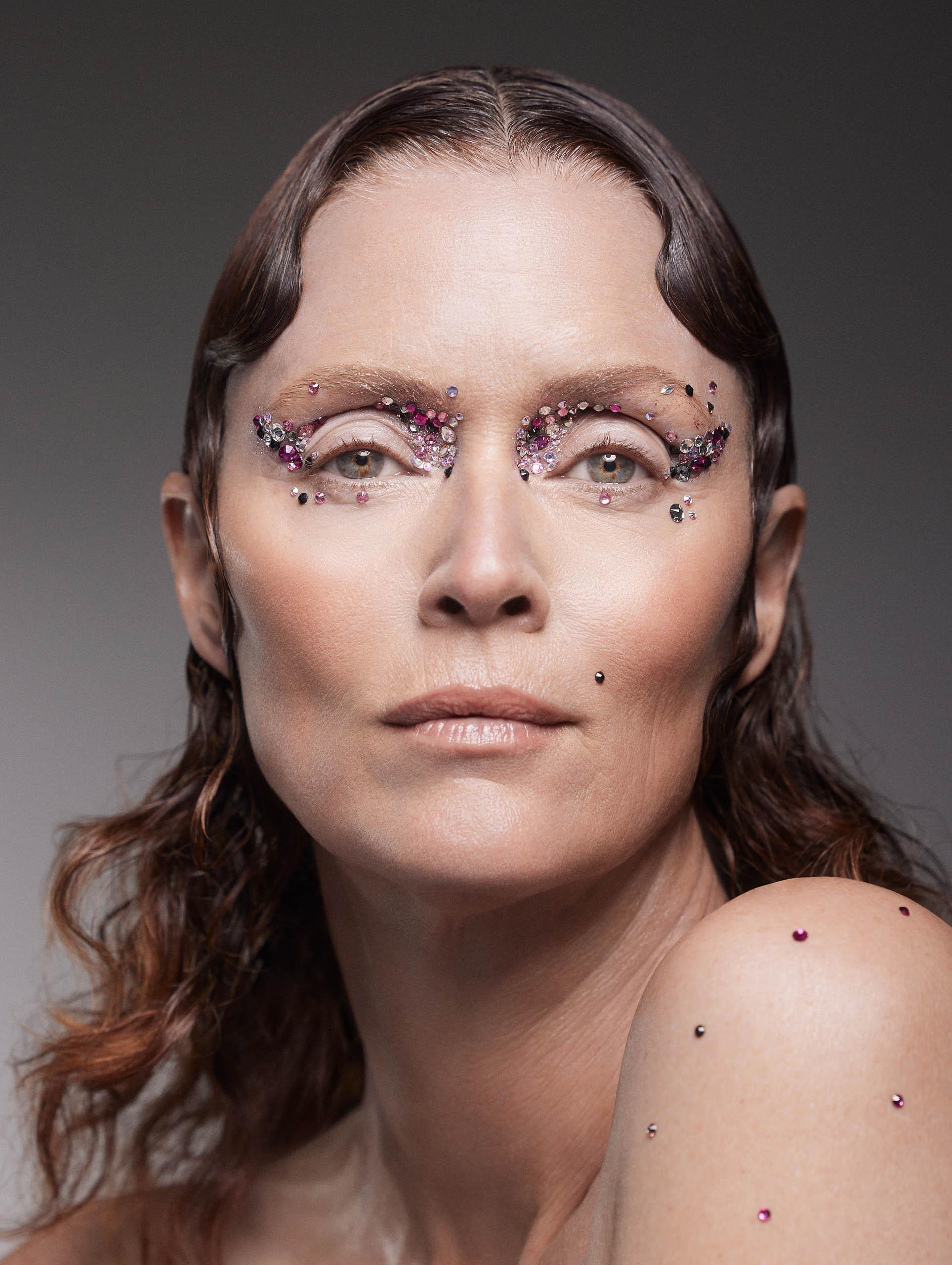 close up of unique face gems on skin