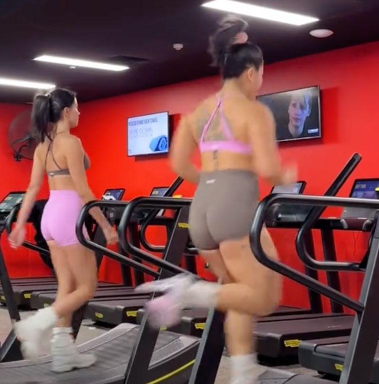 woman grimacing while running on a treadmill
