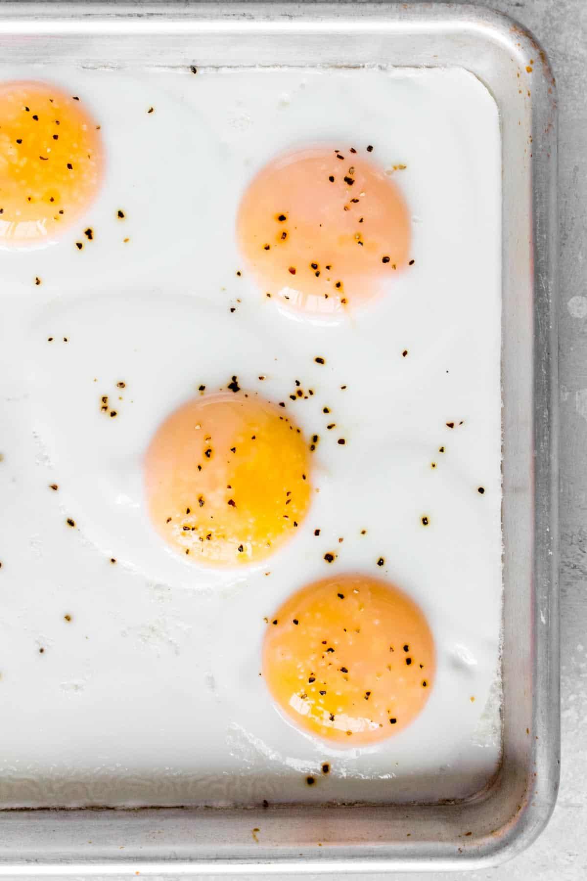 close-up of a perfectly cooked egg yolk on a piece of sheet-pan breakfast, ready to be served