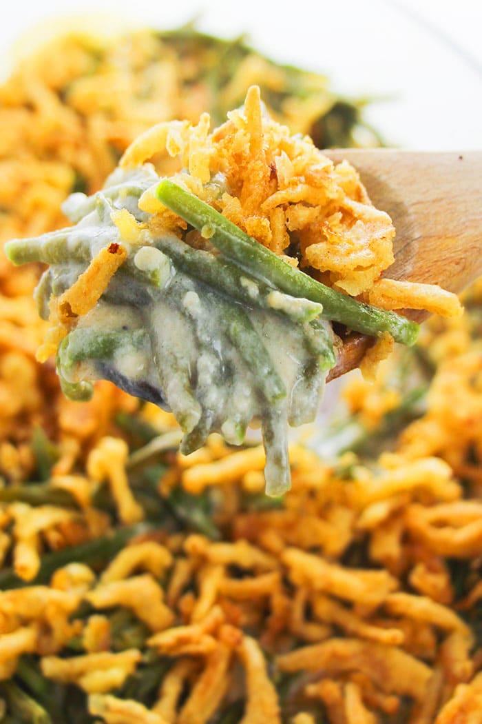 Close-up shot of a serving of sautéed green bean casserole on a plate, garnished