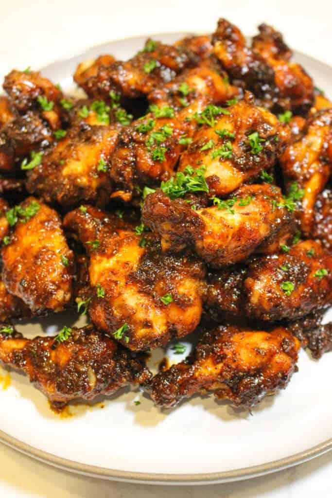 close up shot of brown sugar-chipotle chicken wings on a grill
